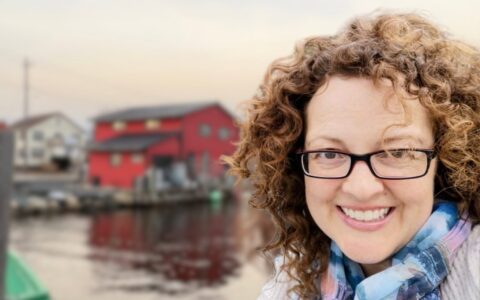 Photo of Stacy Ann Milford in from of a fishing stage